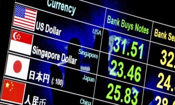 foreign currency exchange rate board with lighting hand in backg