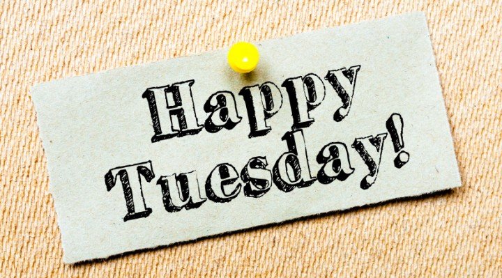Recycled paper note pinned on cork board. Happy Tuesday Message. Concept Image