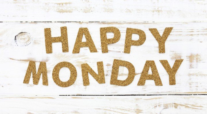 The word happy monday cork on white wood background