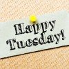 Recycled paper note pinned on cork board. Happy Tuesday Message. Concept Image
