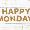 The word happy monday cork on white wood background