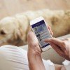 Woman Looking At News App On Smartphone