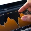 Analyzing stock market graph on a touch screen device.